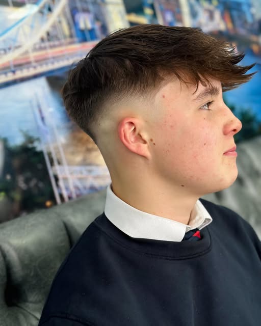 Side view of a smooth skin fade with a longer swept top